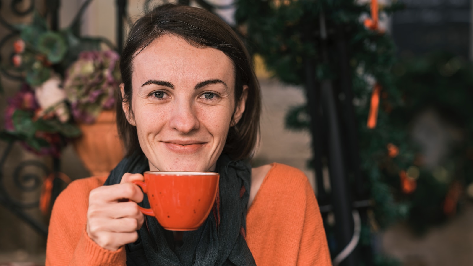 Which Coffee has the Least Caffeine a woman holding a cup of coffee in front of her face