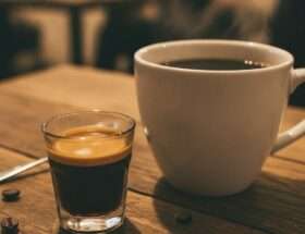 Espresso shot next to a mug of filter coffee