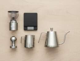 Flat lay of essential home barista coffee accessories