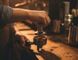 Barista tamping espresso into a portafilter